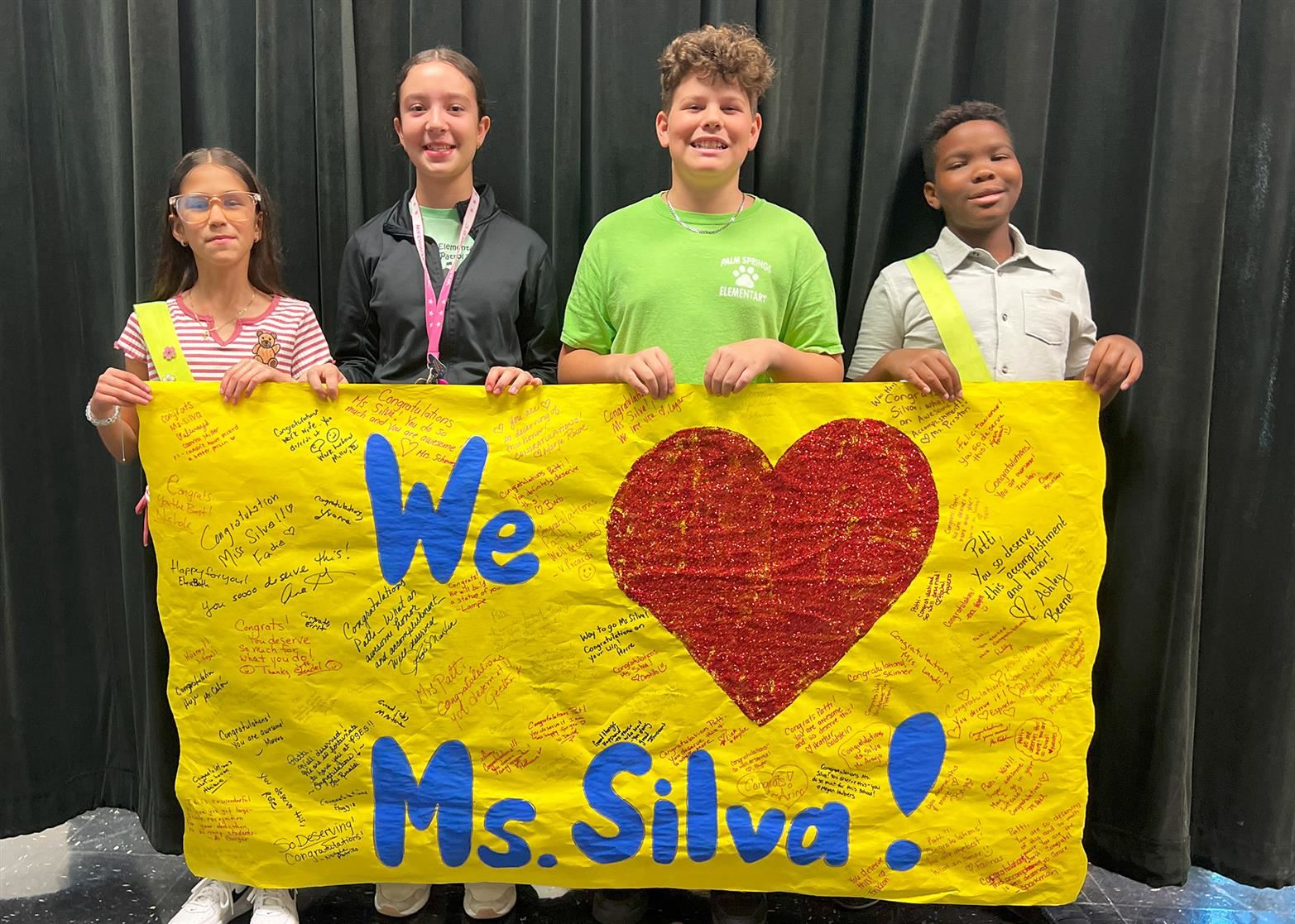  Students waiting to congratulate Ms. Silva with a sign that they made for the event